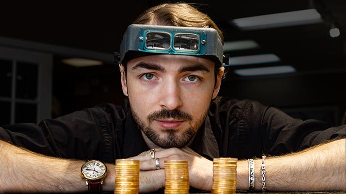 The coin dealer with stacks of gold coins